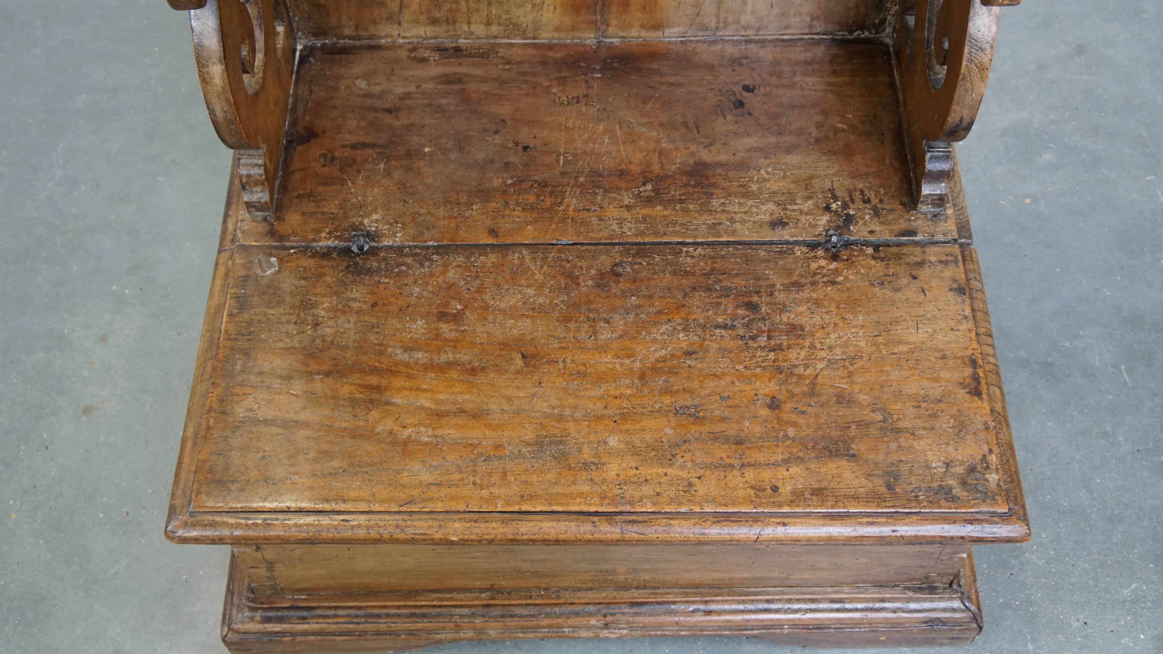 Antique pinewood church pew with storage compartments from the 18th century