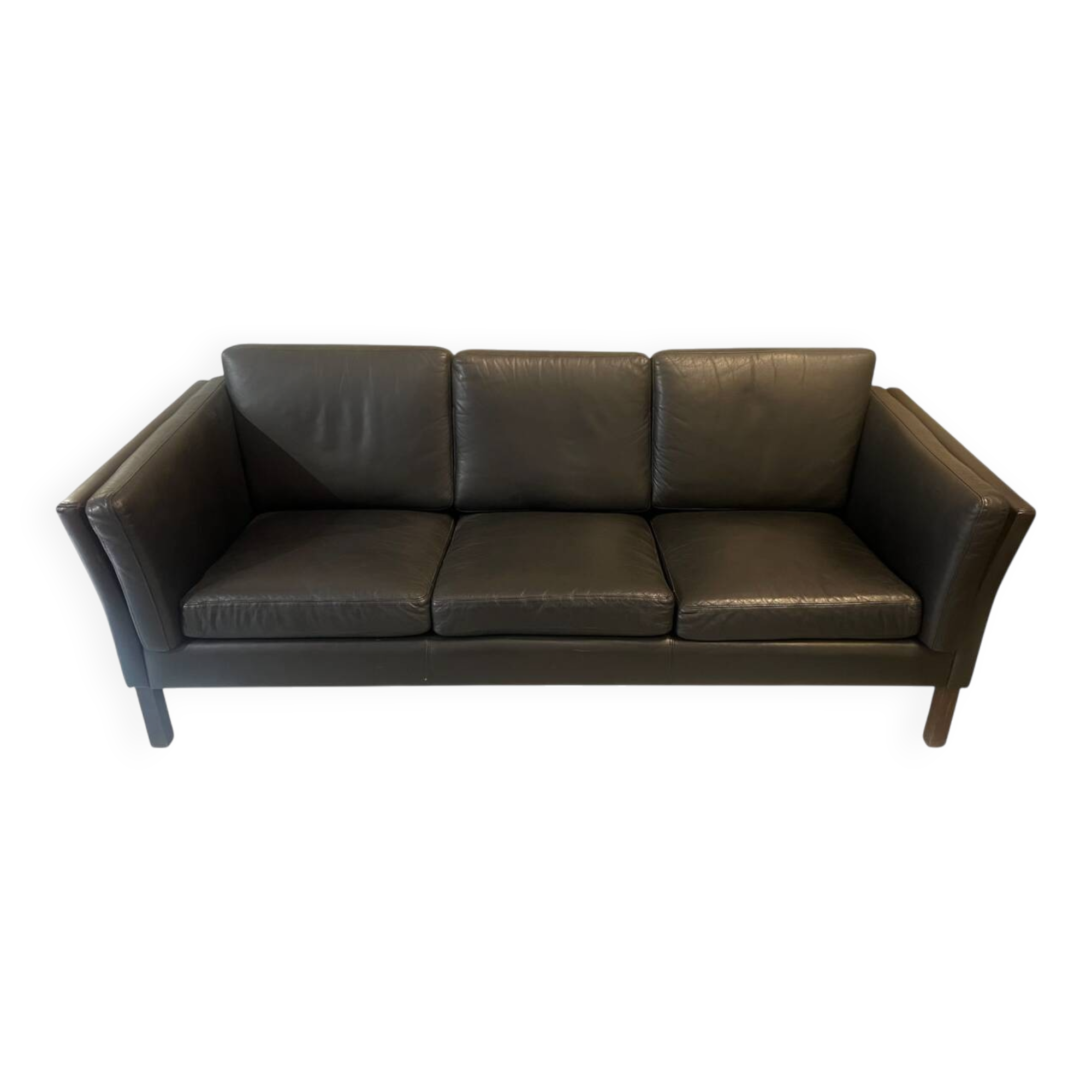 Black leather three-seater sofa