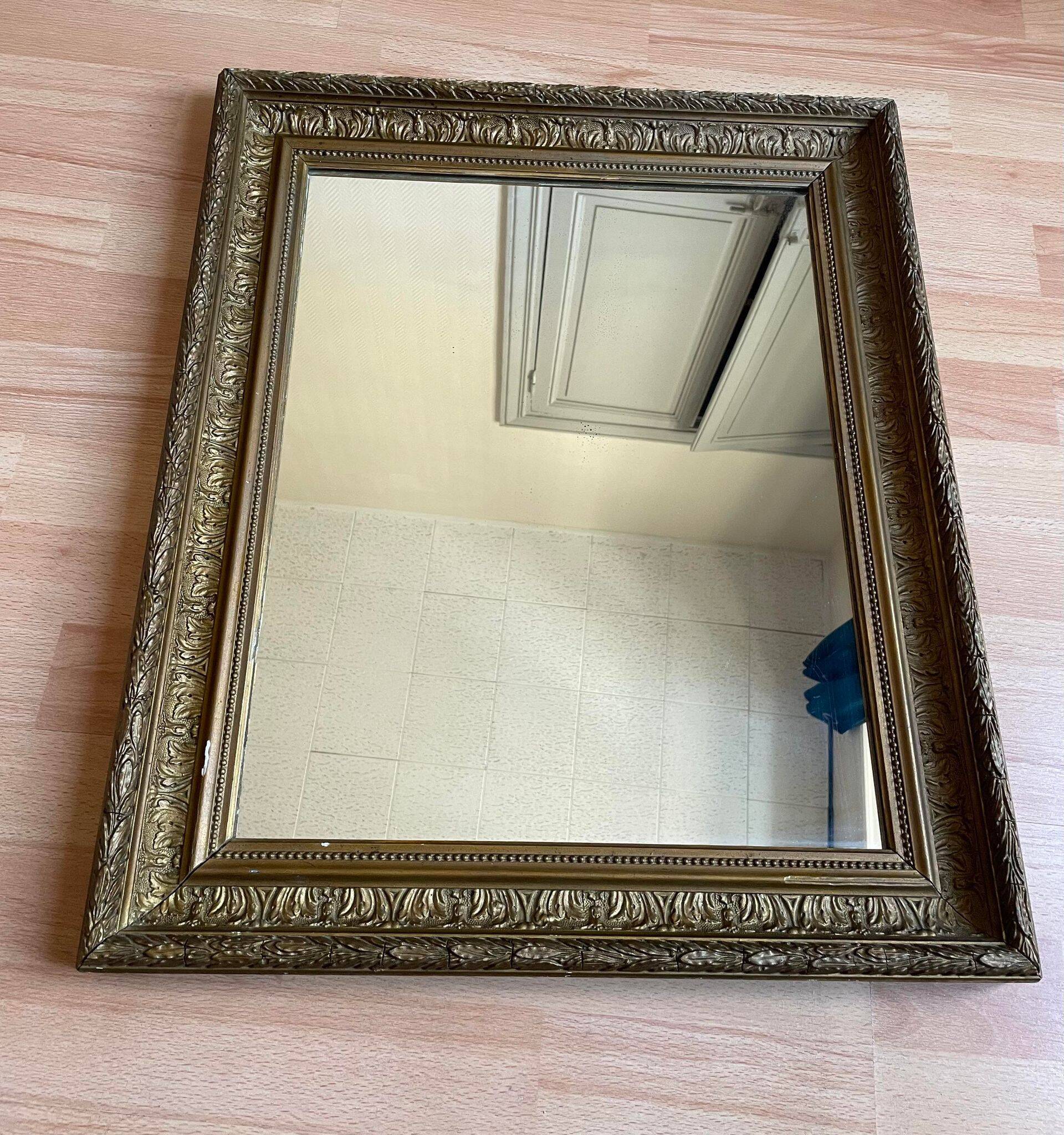 Old mirror with golden wooden frame