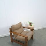 Brown-grey armchair with an oak frame.