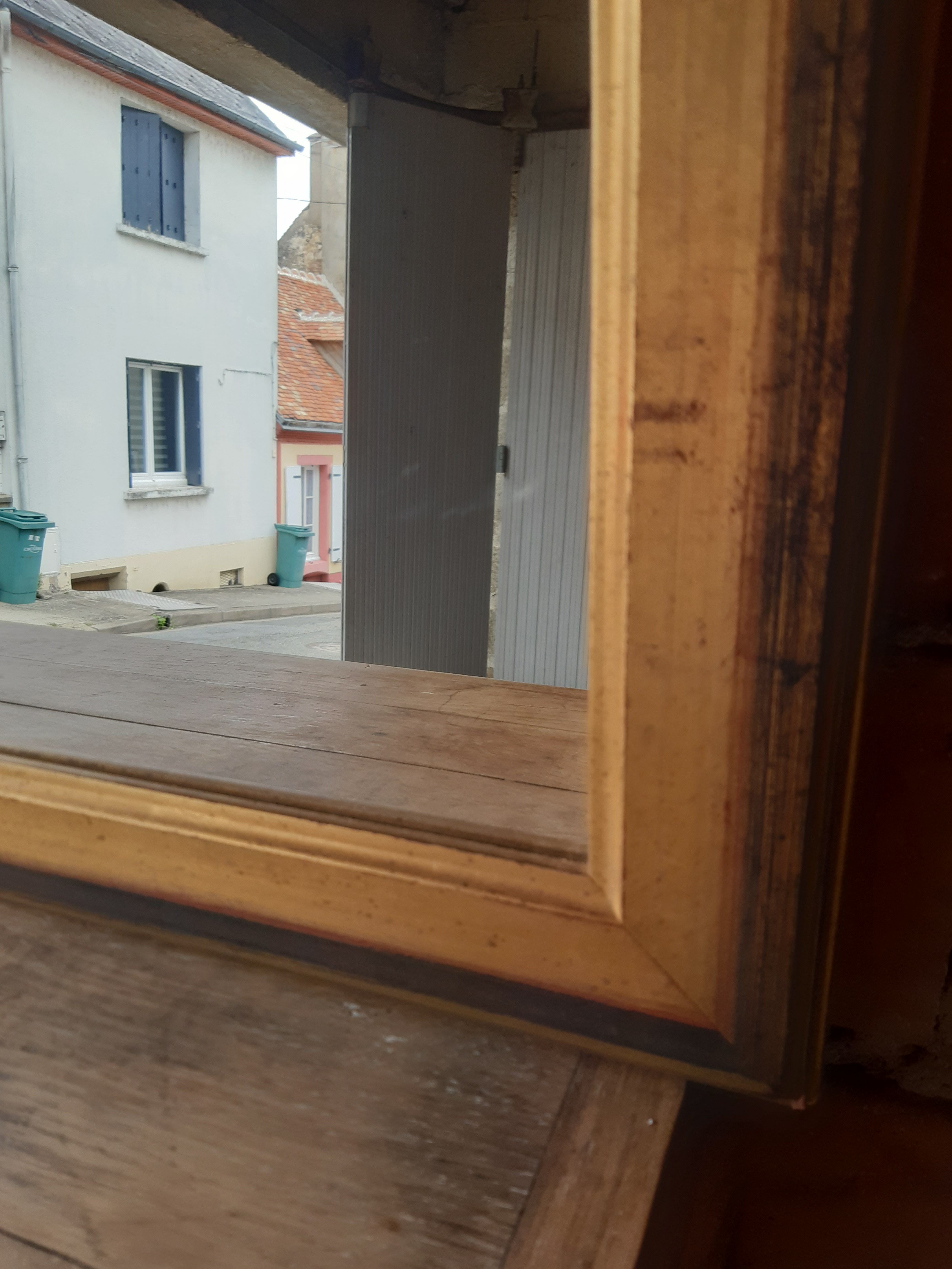Old mirror of period handmade by cabinetmaking and decorated with gold leaf
