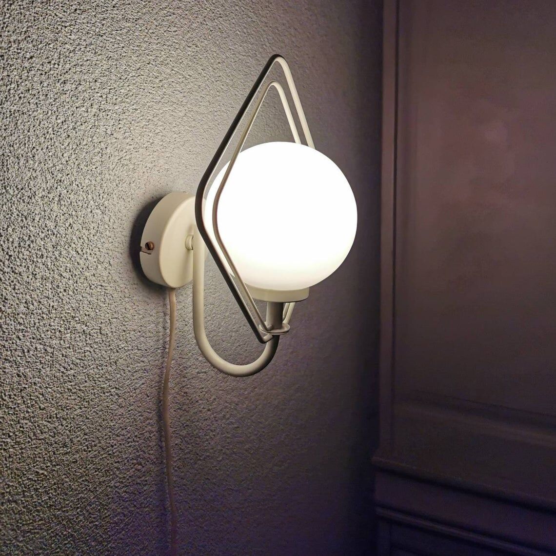 Metal applique with 80s glass sphere