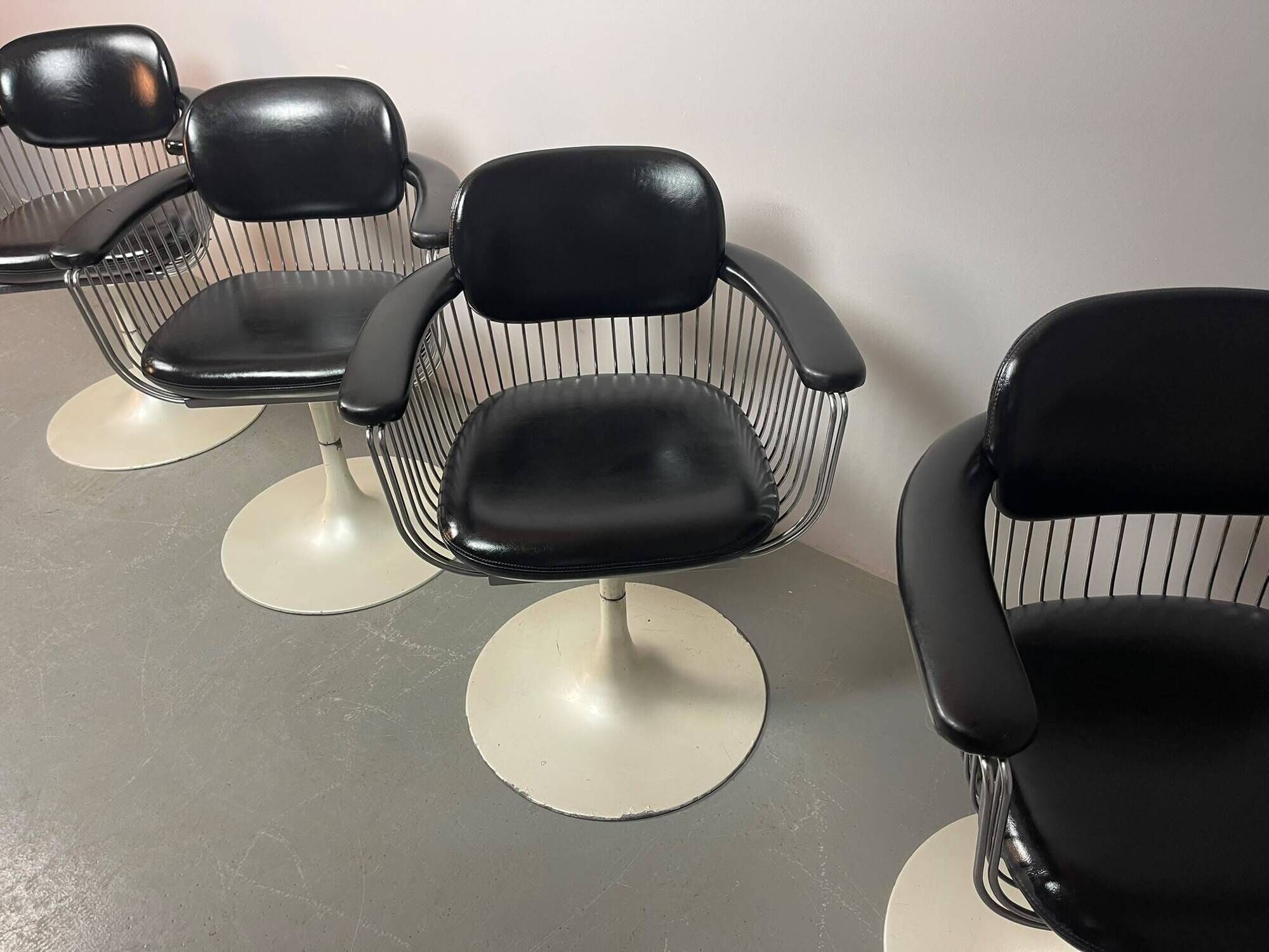 A striking set of four vintage swivel dining chairs