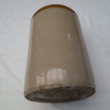Old wiskhey jug in sand