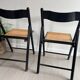 Vintage folding chairs in black wood and cane.