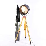 Old industrial spot on wooden tripod