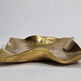 Empty pocket in polished brass representing a crumpled paper, signed CJ, 11.5 cm
