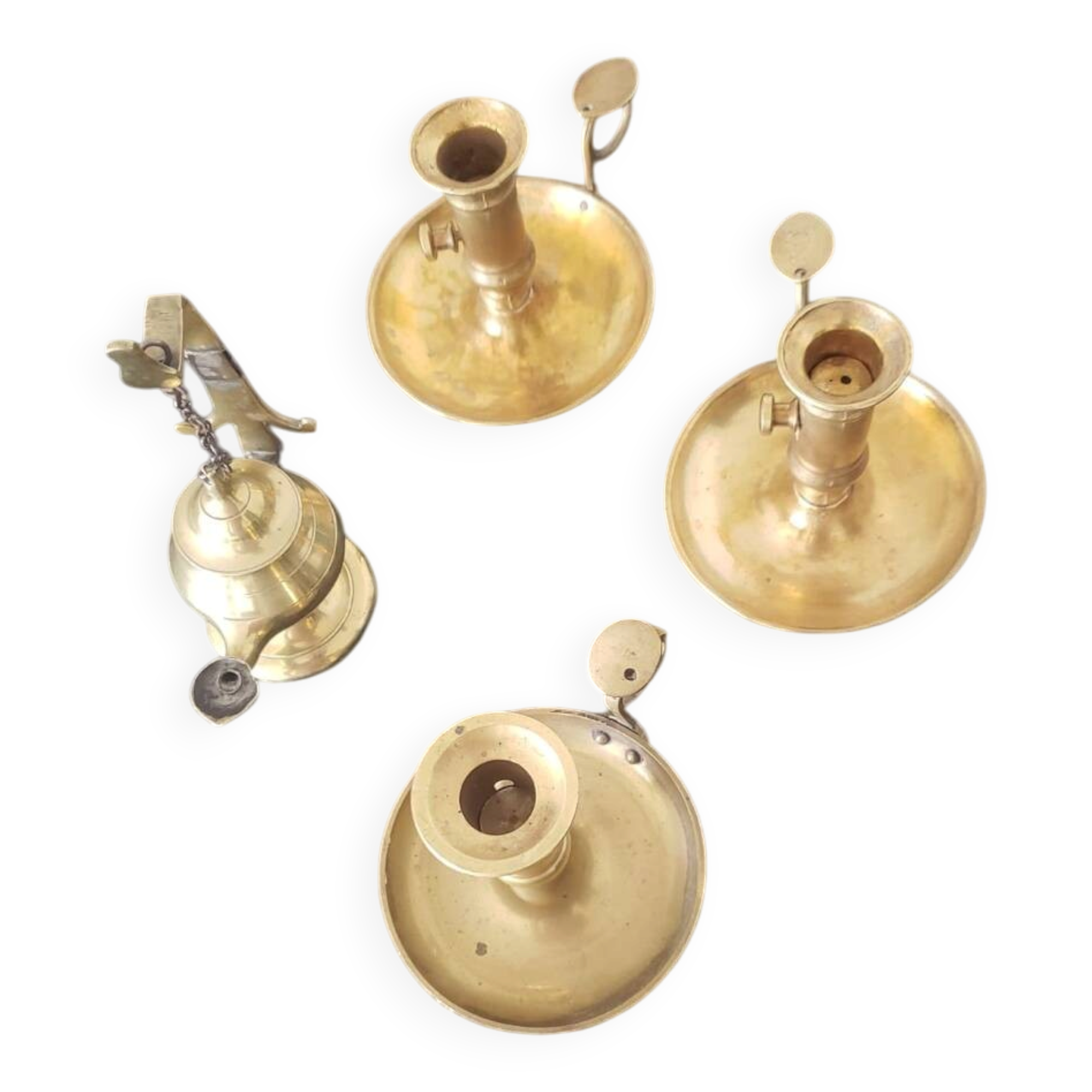Many candlesticks and a small oil lamp.