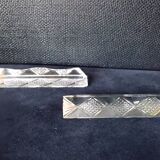 Set of 12 lead crystal knife rests in a triangular shape.