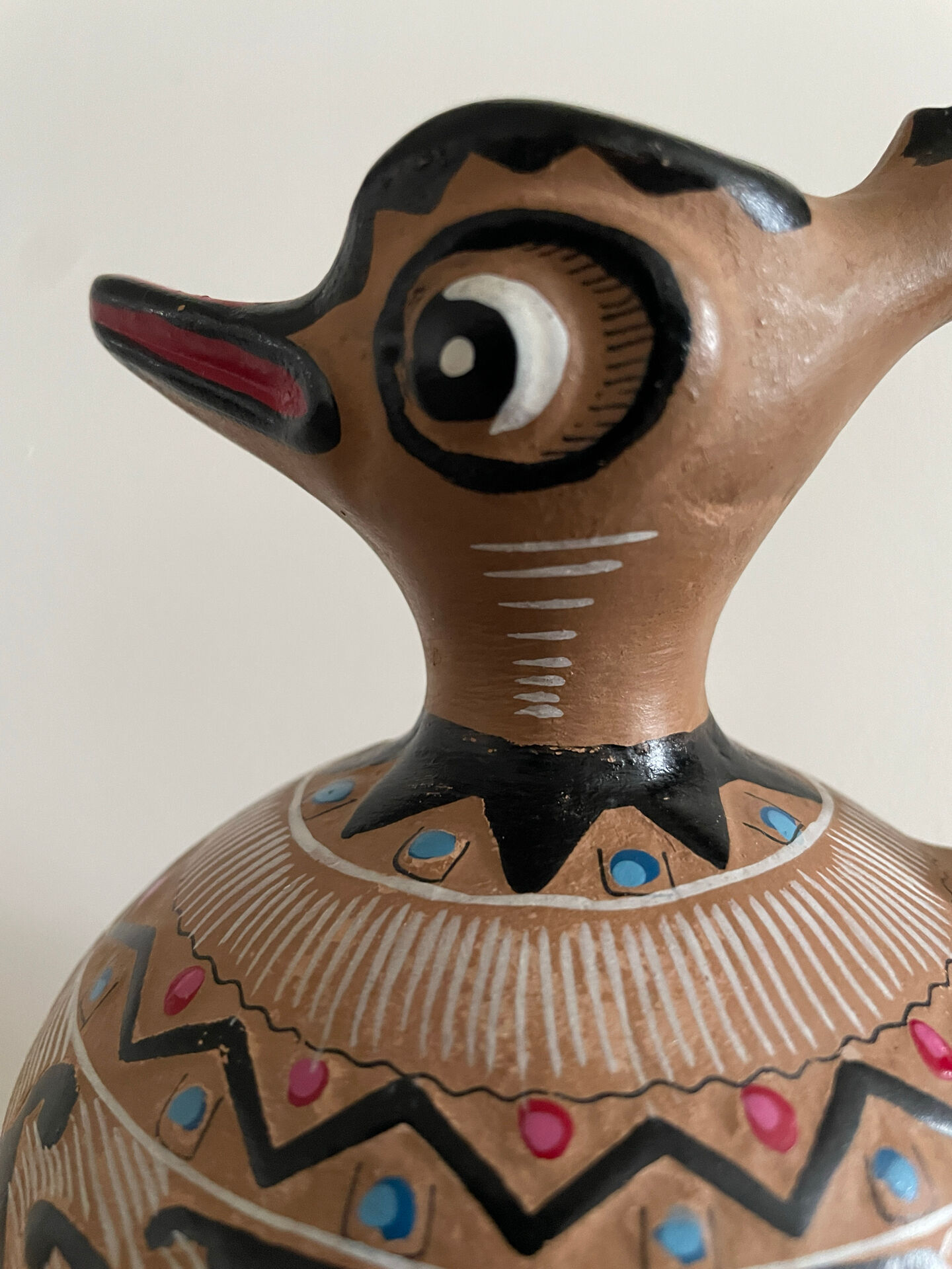 Clay pitcher with a bird head