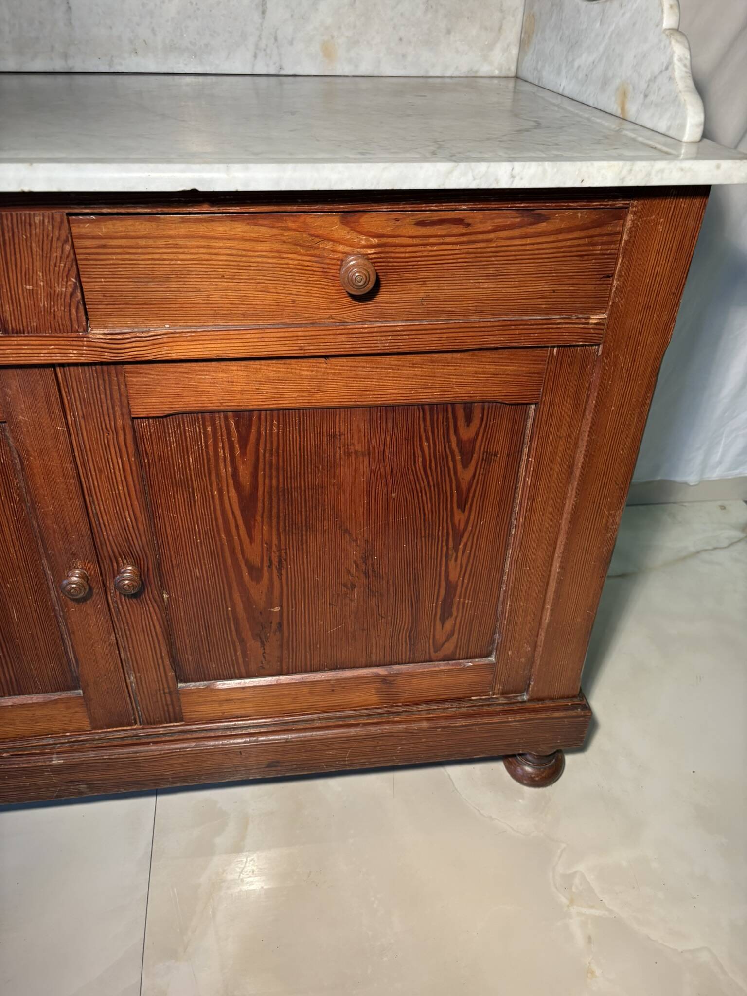 Antique wood and marble kitchen sideboard with carved backsplash