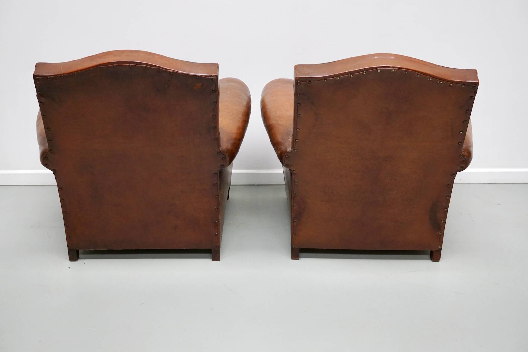Pair of French Cognac Moustache Back Leather Club Chairs, 1940s