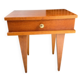 Vintage bedside table with tapered legs.
