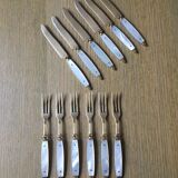 Old brass forks and knives and mother-of-pearl handle
