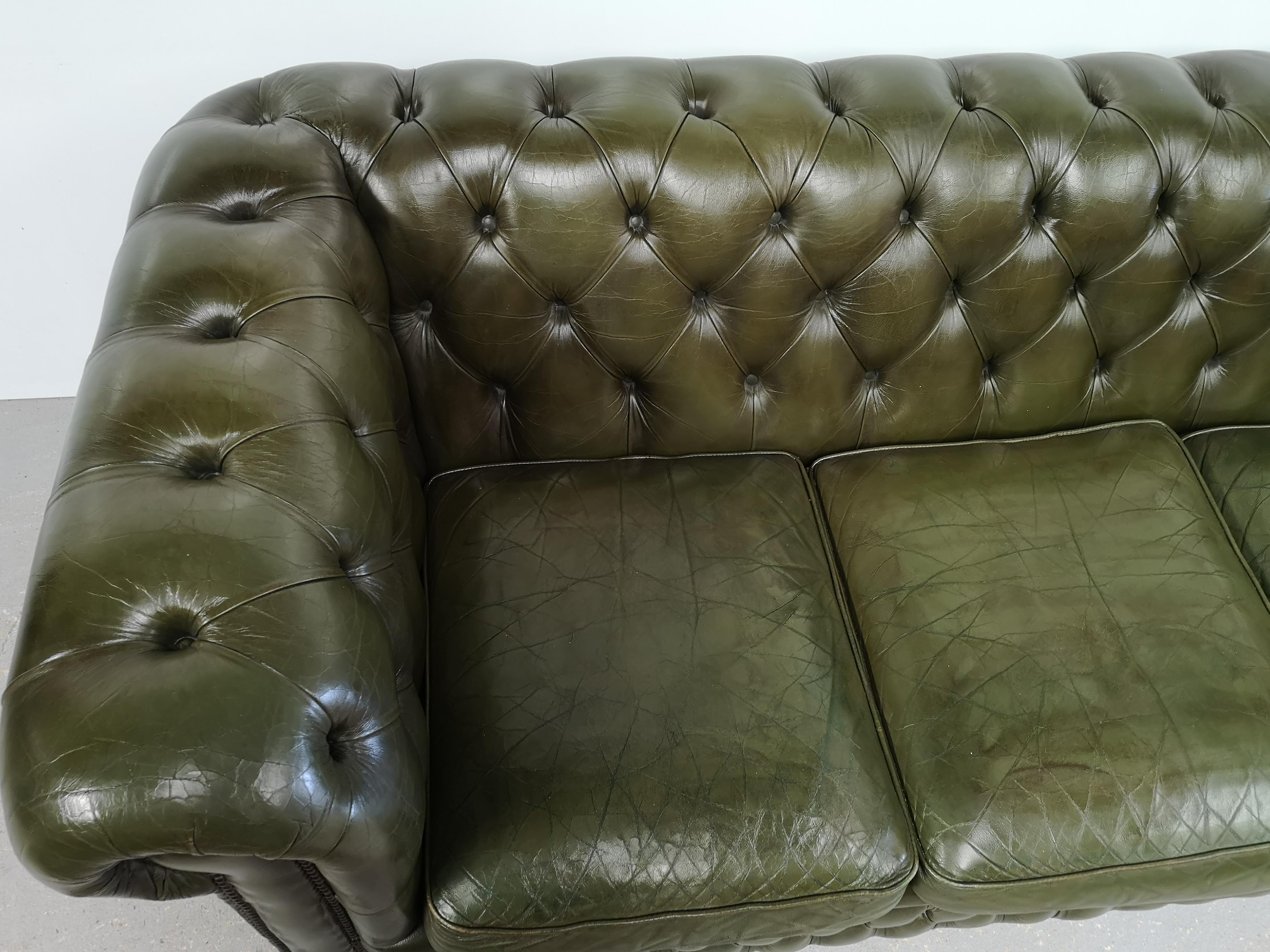 Three-seater green leather Chesterfield sofa