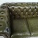 Three-seater green leather Chesterfield sofa