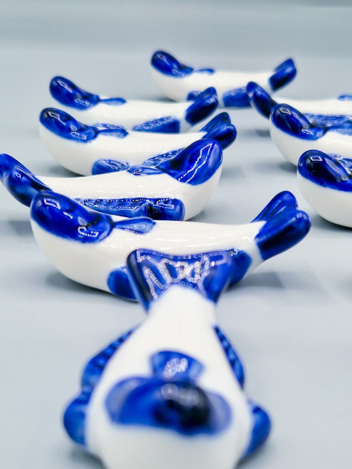 Set of 11 vintage blue and white porcelain fish knife rests.