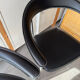 Set of two metal chairs with a brushed finish and black leather.