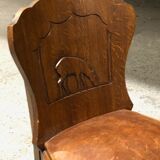 Set of 6 vintage solid wood chairs with animal motif on the back and leather seat