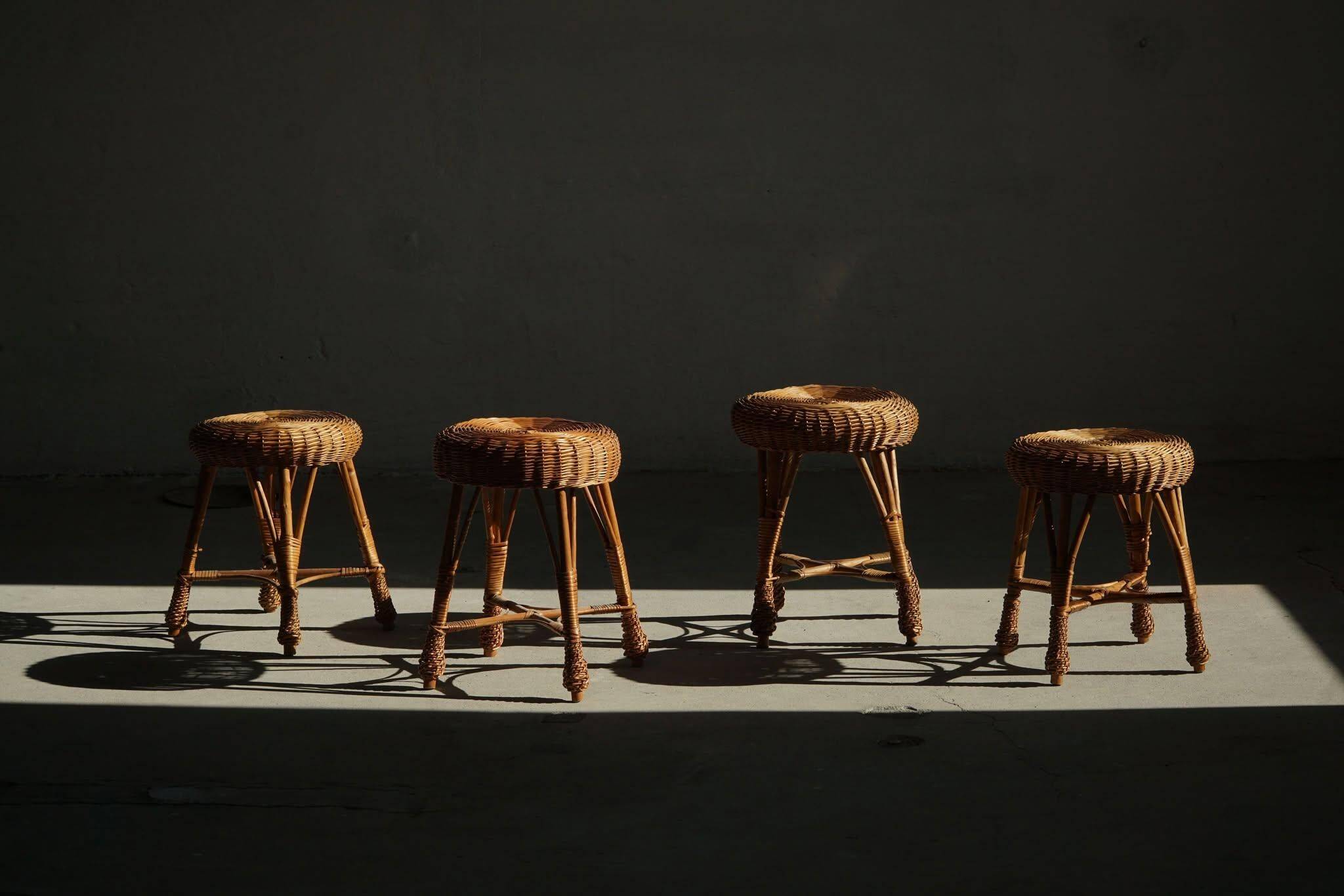 A set of 4 vintage Scandinavian rattan stools, in the style of Tony Paul, from the 1960s.