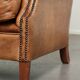 Sheepskin wingback armchair in a light cognac colour in English style