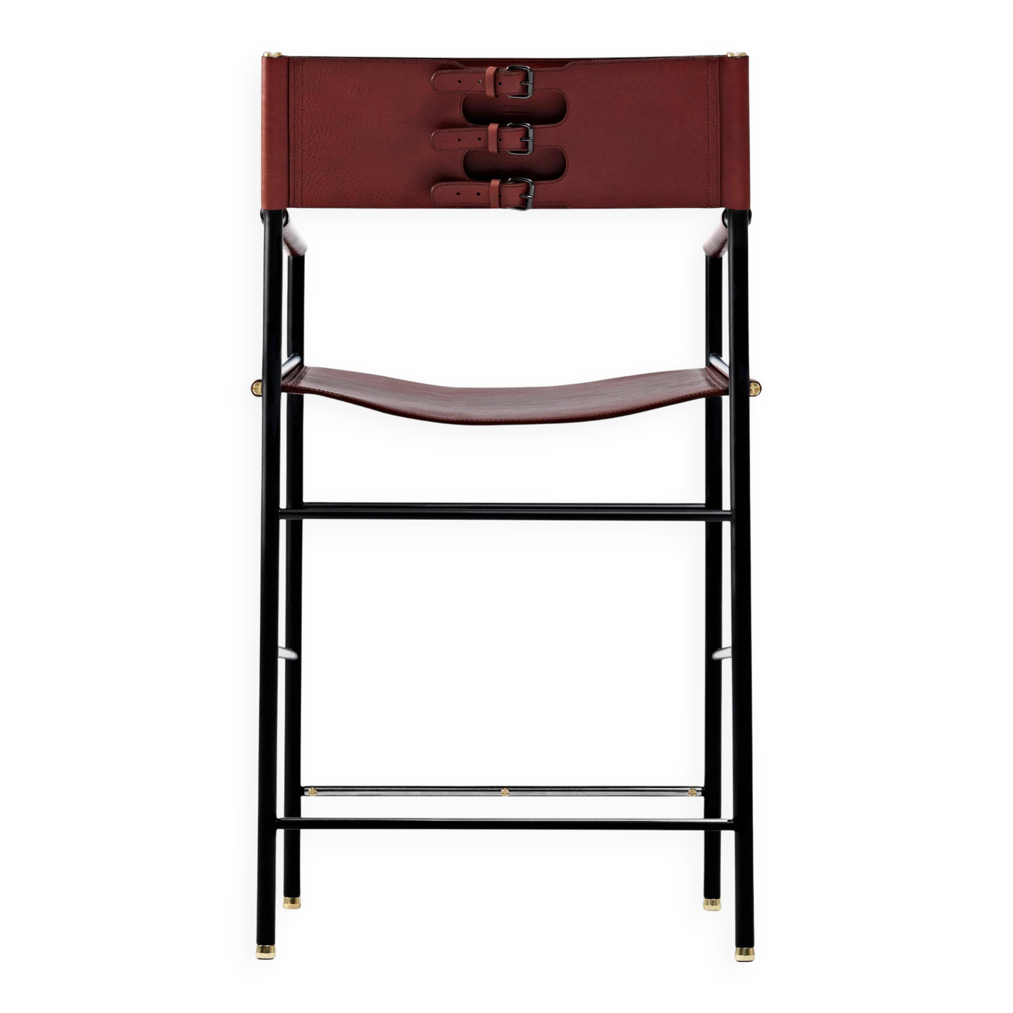 Contemporary classic bar stool with cognac leather backrest and black rubber metal.