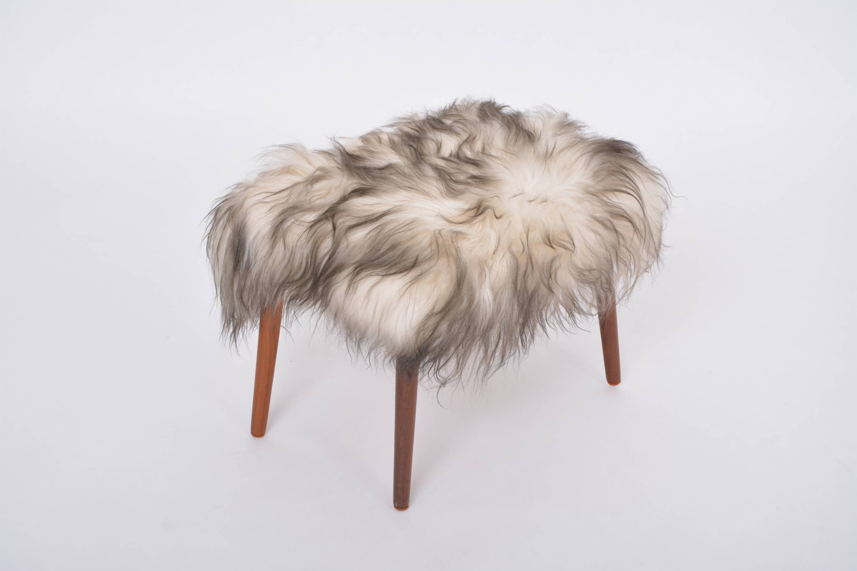 Danish Mid-century Modern stool reupholstered in white and black sheep skin