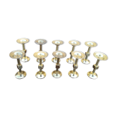 Lot of ten peaks candles in brass