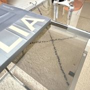 Set of 2 vintage nesting coffee tables in chrome metal and smoked glass.