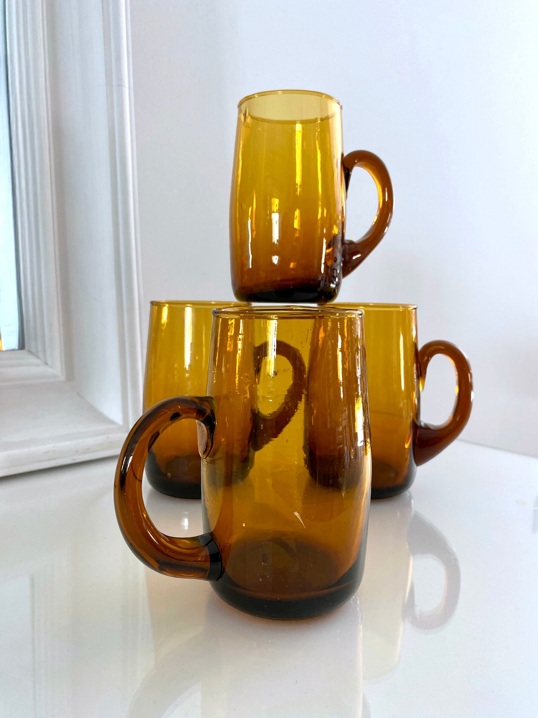 4 mugs/ mugs in vintage blown amber glass