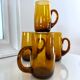 4 mugs/ mugs in vintage blown amber glass