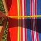 vintage wooden deck chair with red, blue, and yellow striped fabric