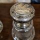 Pair of antique Louis XVI style bottles in finely engraved crystal and silver.