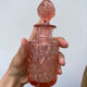 Art Deco perfume bottle in old amber pink glass