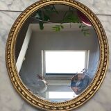 Large oval mirror in wood gilded with fine gold