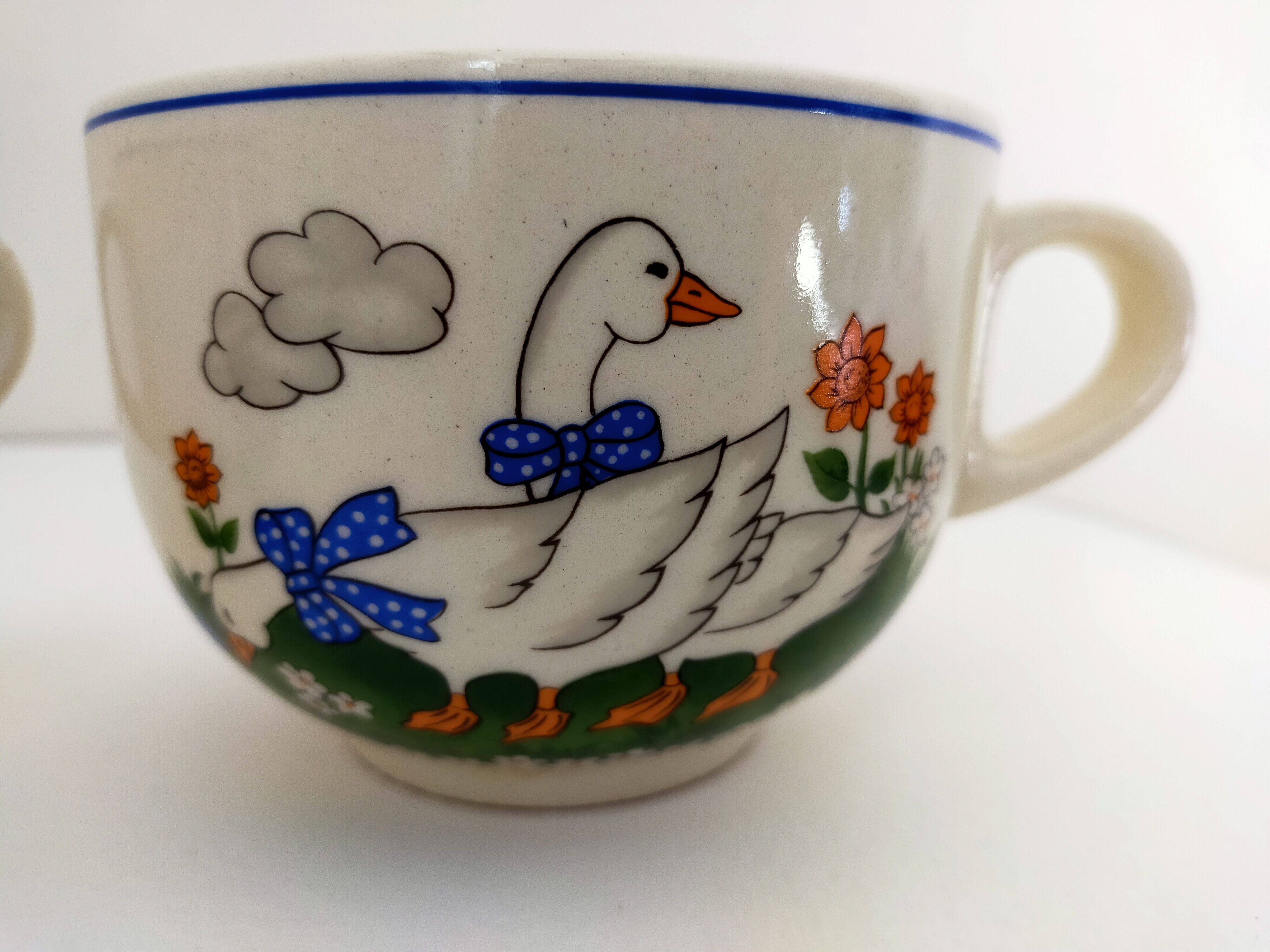 Paire de bols blancs avec anse vintage faïence art déco décor animalier:oies aux rubans bleus