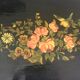 Black wooden tray with gilding and Russian motifs painted with red and green flowers
