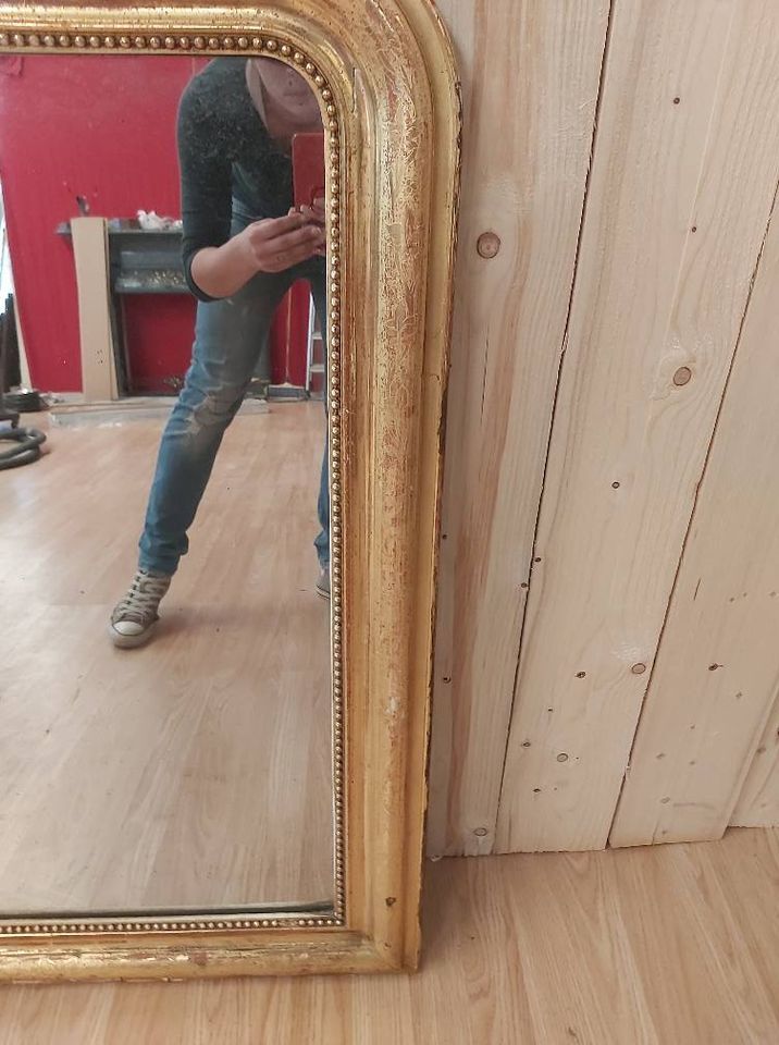 Golden Louis Philippe mirror with golden leafy