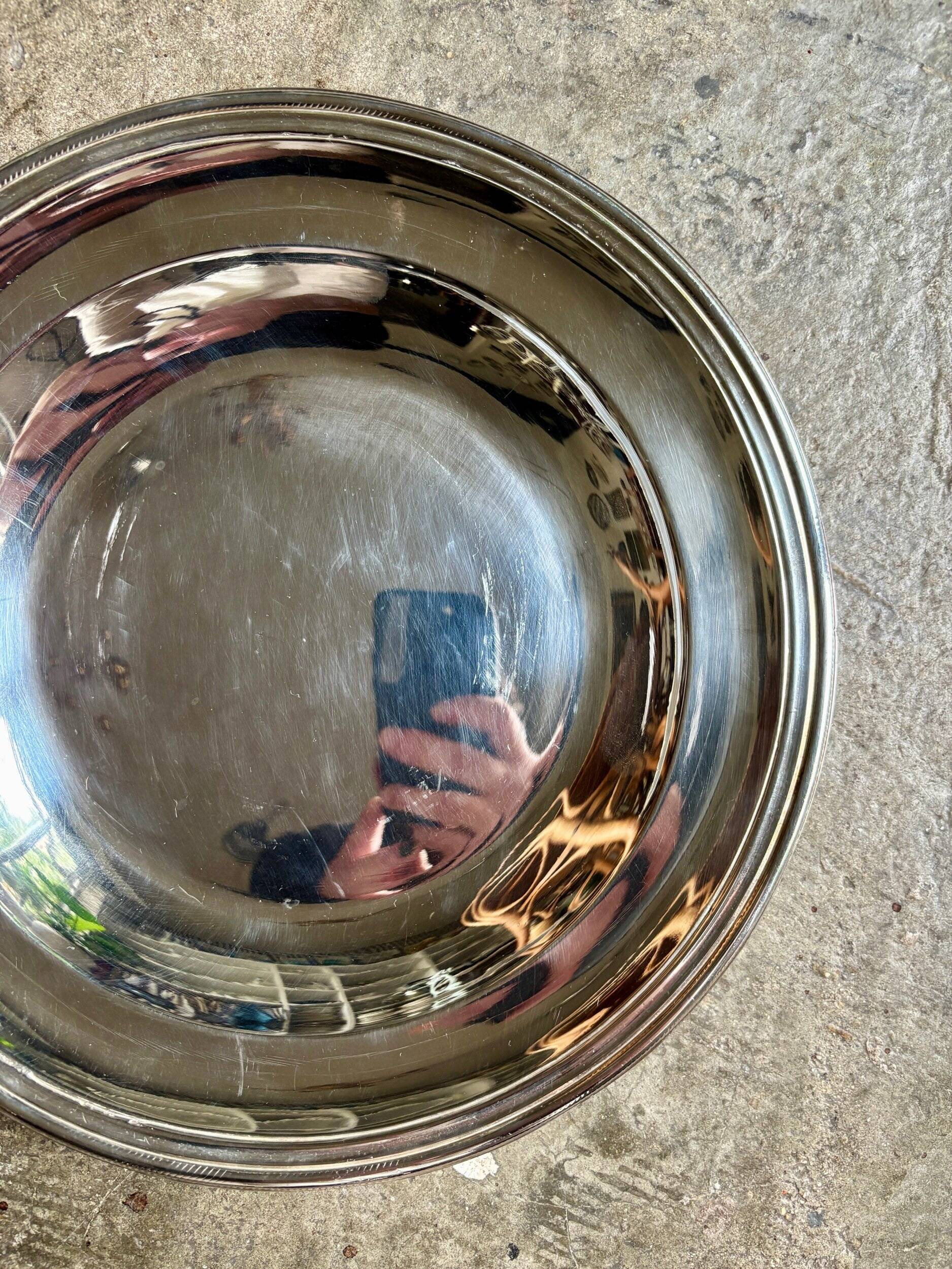 Round, hollow silver-plated metal dish