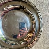 Round, hollow silver-plated metal dish