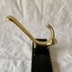 Vintage coat rack in lacquered metal with three golden aluminum hooks