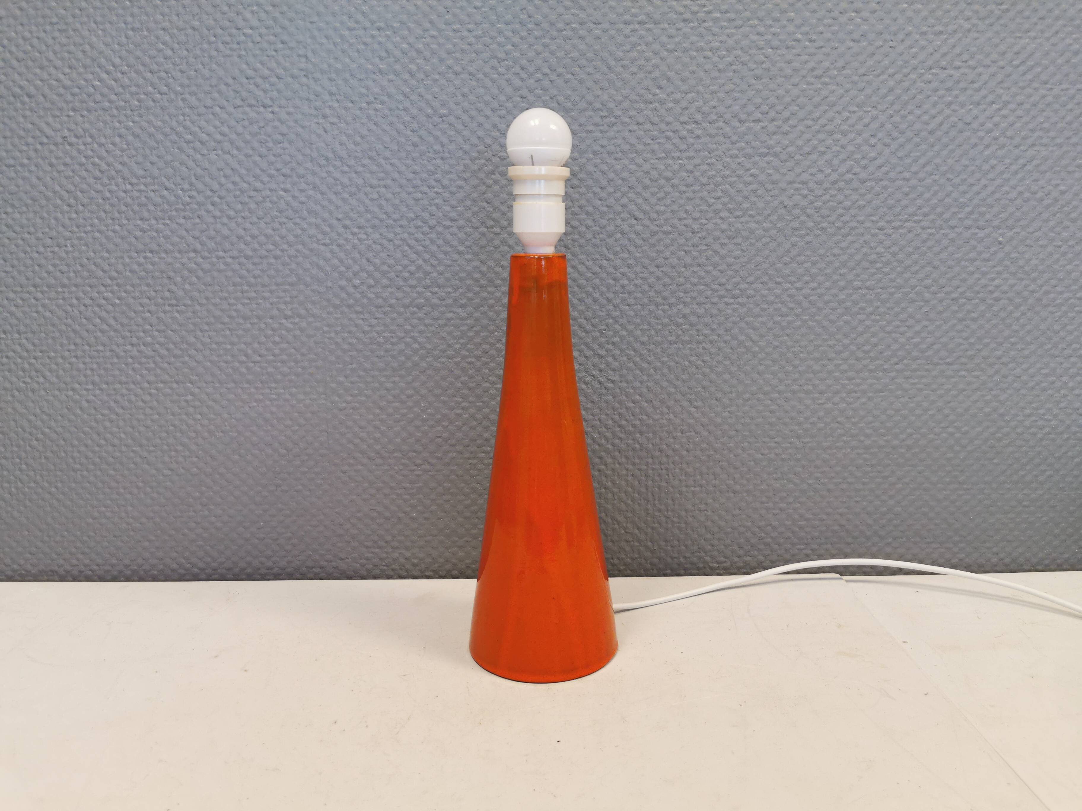 Ceramic table lamp with partial orange glaze.