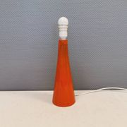 Ceramic table lamp with partial orange glaze.