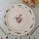 7 mismatched antique dessert plates accompanied by a pie dish
