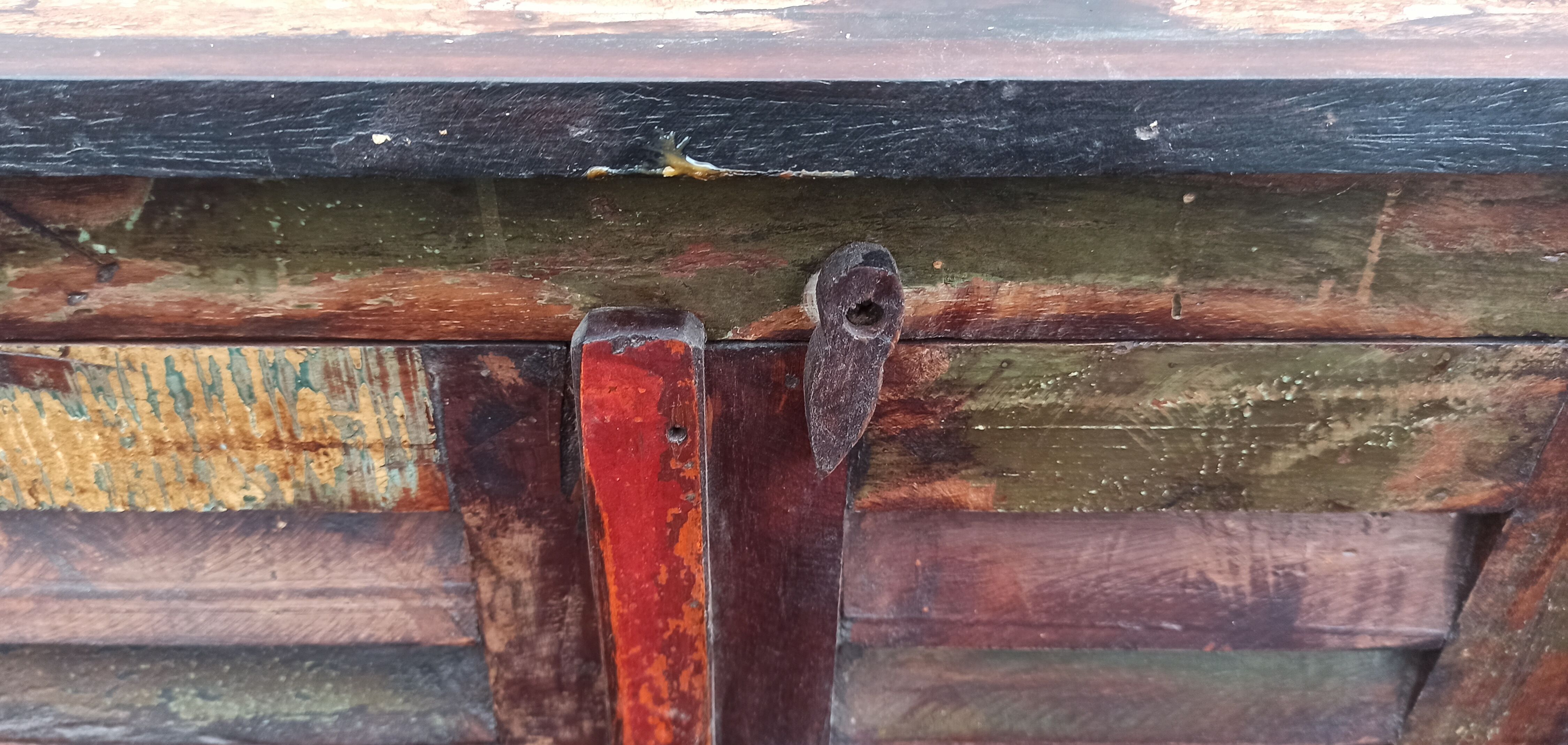 Furniture low in colorful wood. 12 drawers and 1 door