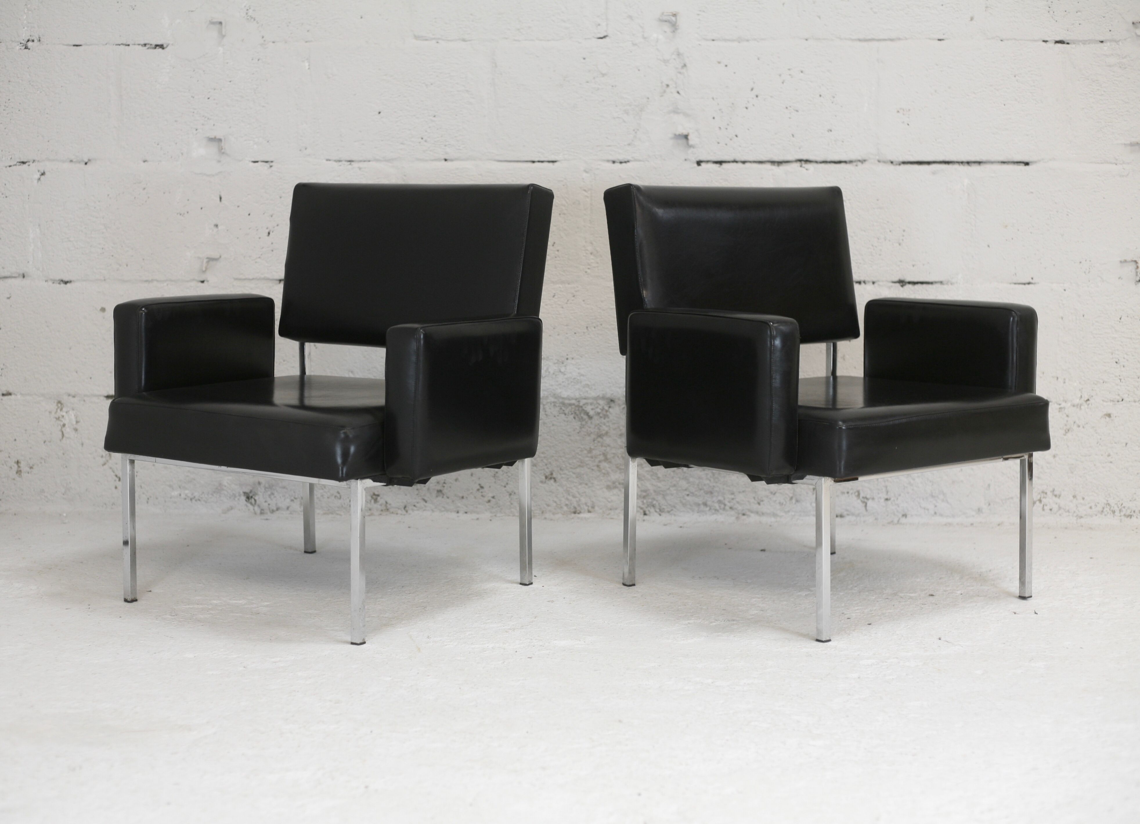 Pair of stainless steel, black leather-like armchairs, France, circa 1970