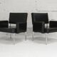Paire de fauteuils piètement inox, simili-cuir noir, France, circa 1970