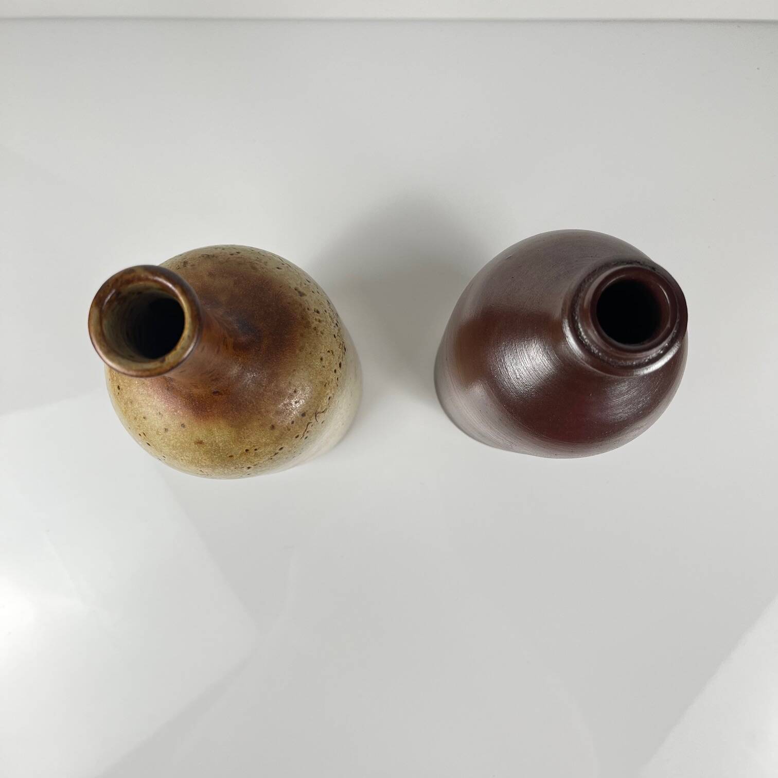 Duo of speckled stoneware and burgundy bottles, 20th century