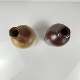 Duo of speckled stoneware and burgundy bottles, 20th century