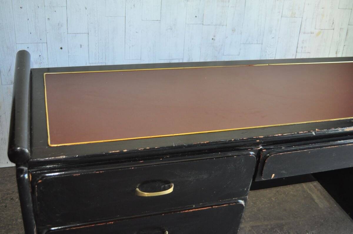 Hungarian Art Deco desk in black painted wood with a brown top and metal handles.